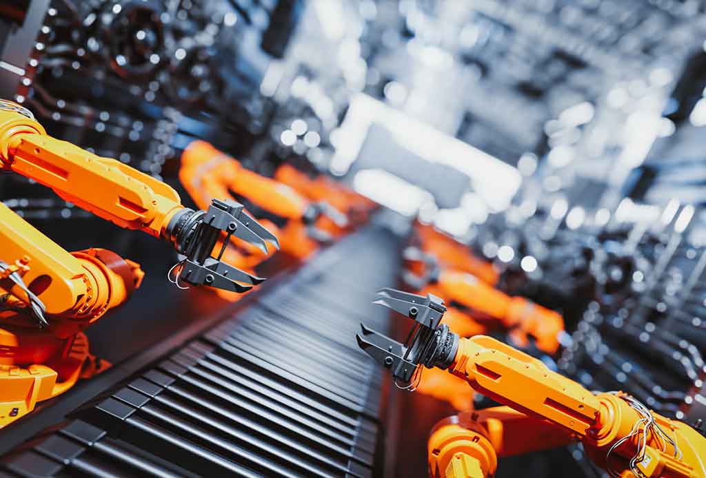 Robotic arms along assembly line in modern factory