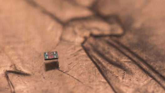 credited to Michael Simari, of the University of Michigan, and depicts a microrobot on a U.S. penny, showing scale.