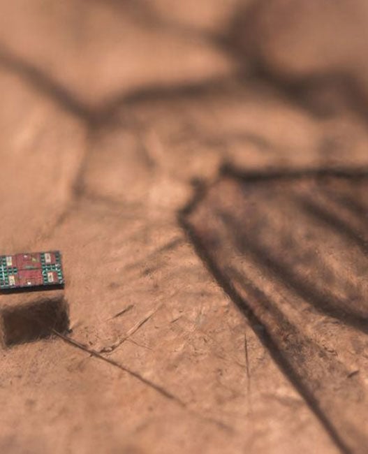 credited to Michael Simari, of the University of Michigan, and depicts a microrobot on a U.S. penny, showing scale.